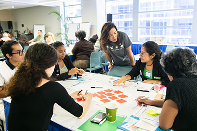 Faculty and students working in groups